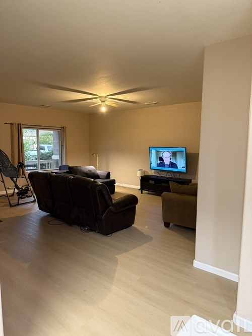 A living room with a television and a couch.