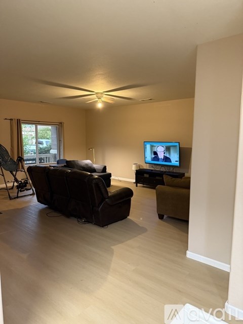 A living room with a television and a couch.