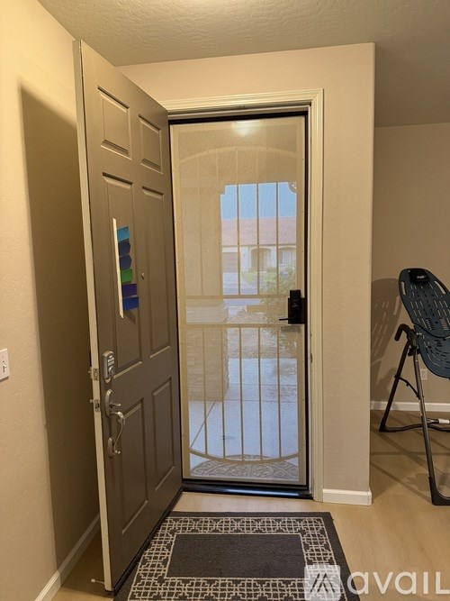 A room with a door leading to a balcony.