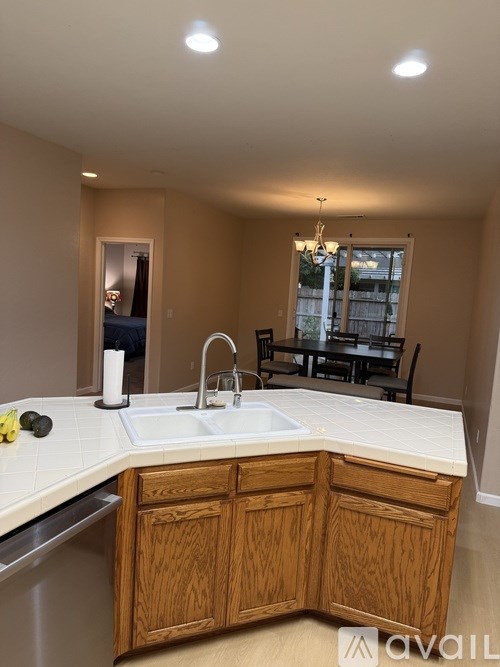 A kitchen with wooden cabinets and a white countertop.