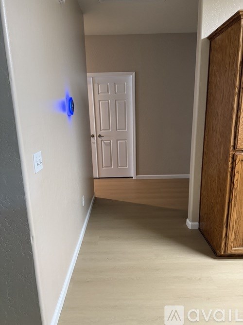 A hallway with a door at the end.
