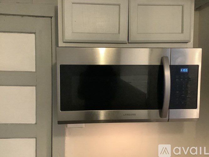 A Samsung microwave with a digital display showing 1:55.