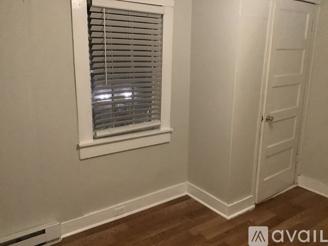 A room with a window and a door.