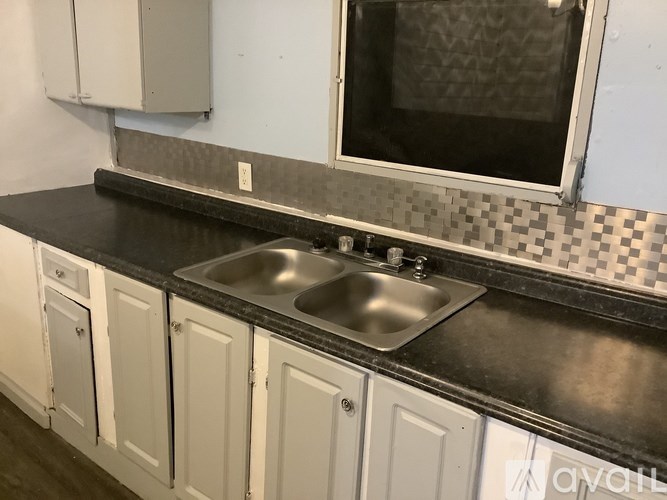 A kitchen with a sink and a window.