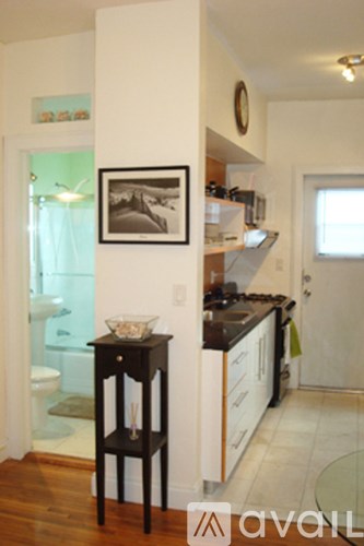 A kitchen with a table and a framed black and white photo on the wall.