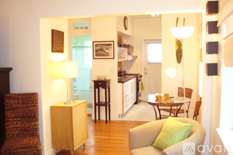A living room with a brown chair and a green cushion.