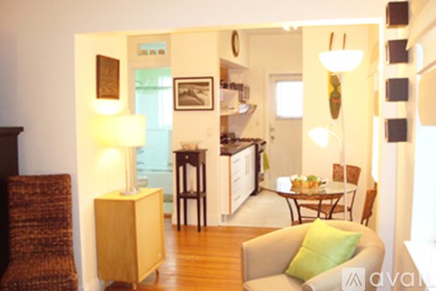 A living room with a brown chair and a green cushion.