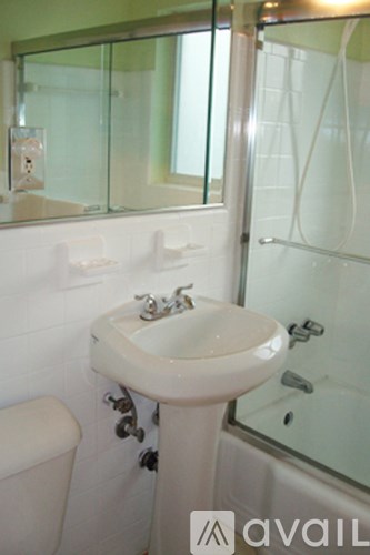 A bathroom with a sink, toilet and shower.