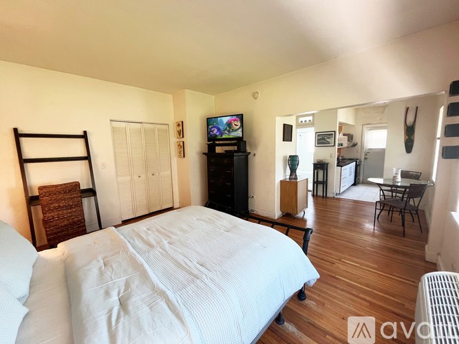 A bedroom with a large bed and a television.