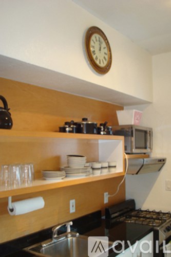 A kitchen with a clock on the wall.