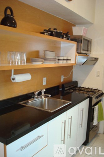 A kitchen with black countertops and white cabinets.