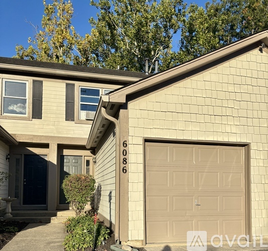 A house with the number 6086 on the garage door.