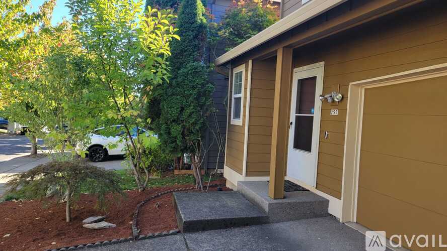 A small house with a brown garage door is shown.