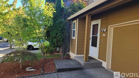 A small house with a brown garage door is shown.