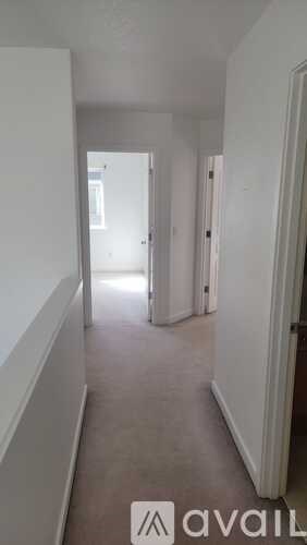 A long hallway with a door at the end.