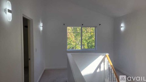 A room with a window and a staircase.