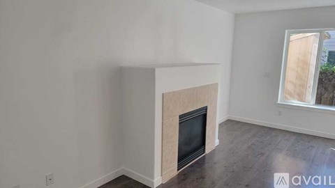 A room with a fireplace and a window.