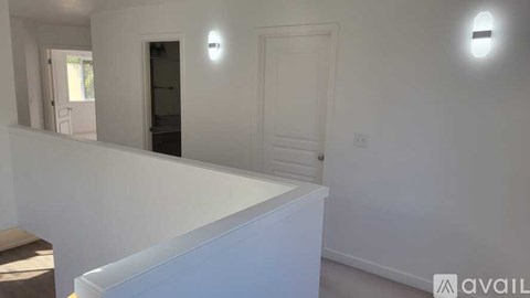 A white room with a door and a window.