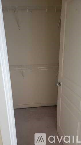 A small, empty room with a door and a wall.