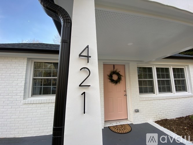 A white house with a number 421 on the front.