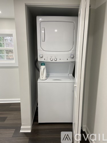 A white washing machine is in a small space.