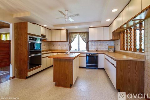 A kitchen with wooden cabinets and a central island.