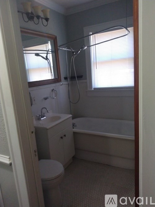 A bathroom with a toilet, sink, and bathtub.
