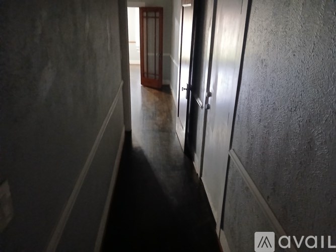 A hallway with a door at the end.