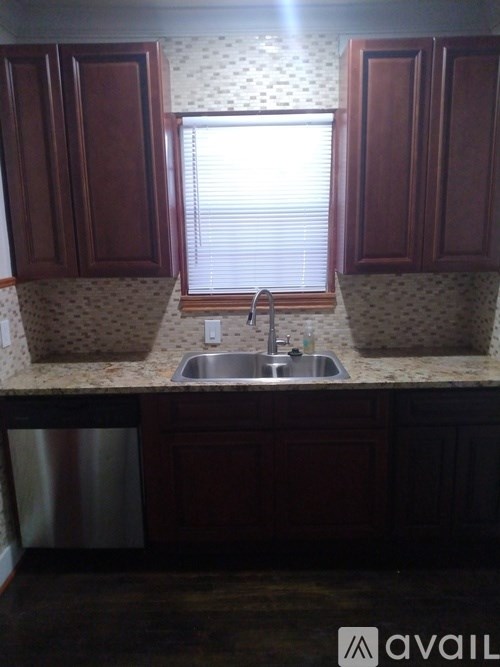 A kitchen with a sink and cabinets.