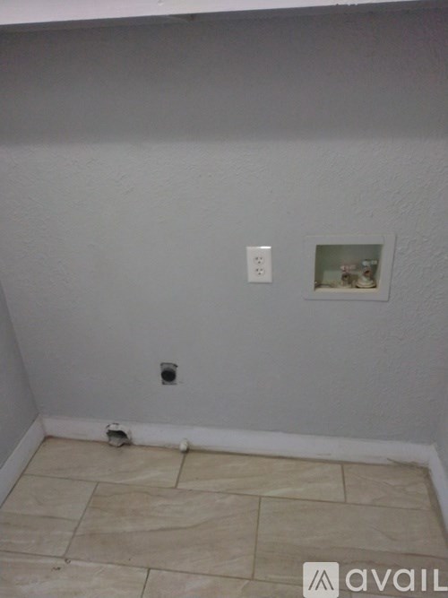 A room with a tile floor and a picture on the wall.
