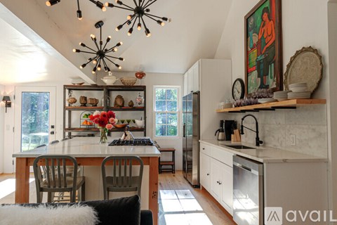 A kitchen with a table and chairs in the middle of the room.