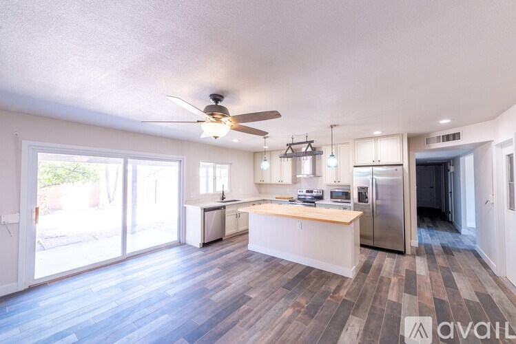 A kitchen with a refrigerator, stove, and oven is available for rent.