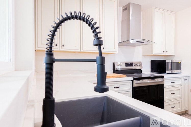 A kitchen with a sink and a vacuum cleaner.