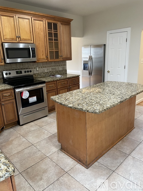 A kitchen with granite countertops and stainless steel appliances.