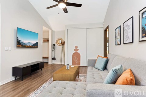 A living room with a grey couch and a coffee table in front of it.