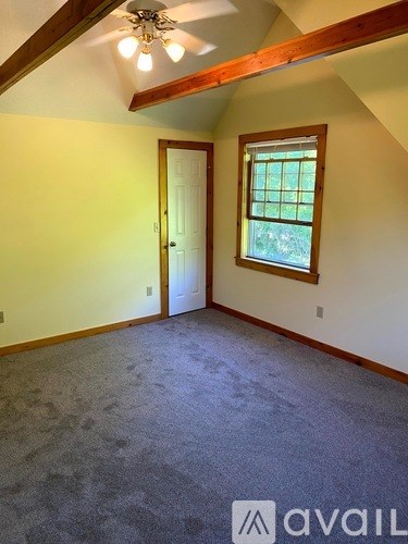 A room with a window and a door.