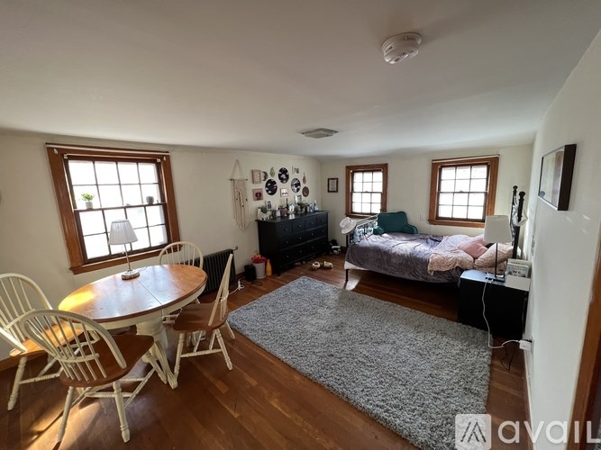 A living room with a dining table and chairs.