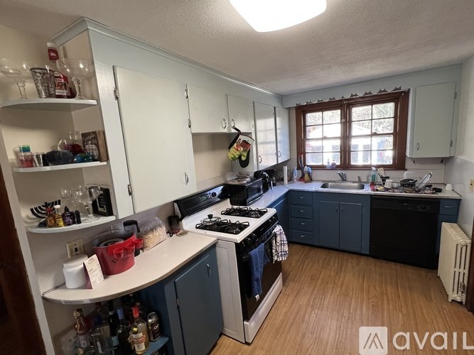 A kitchen with a white countertop and a black stove.
