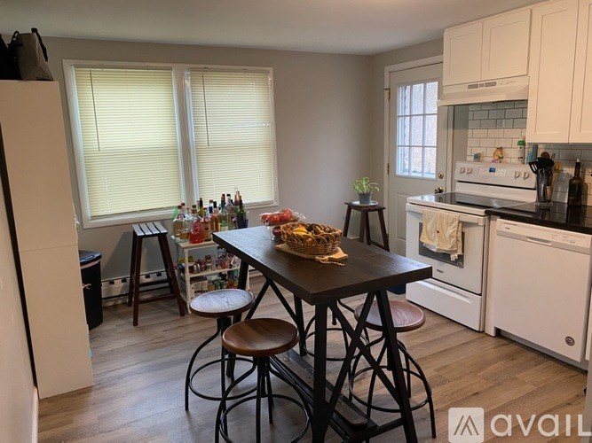 A kitchen with a table and chairs in the middle of the room.