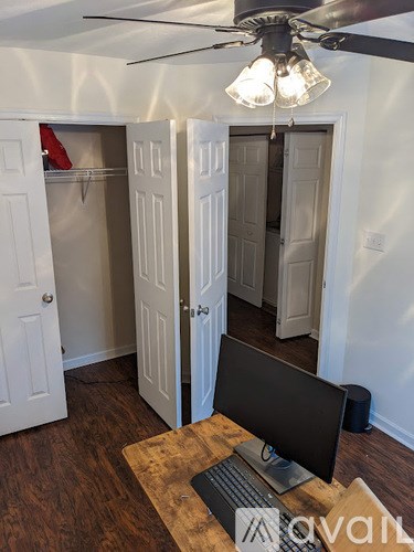 A room with a desk and a computer on it.
