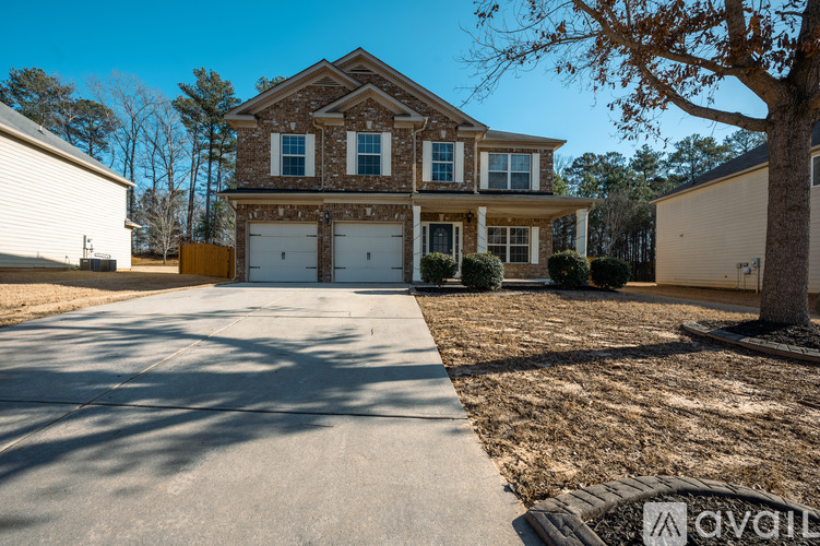 A large house with a driveway in front of it.
