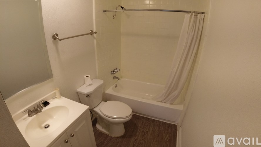 A bathroom with a toilet, sink, and bathtub.