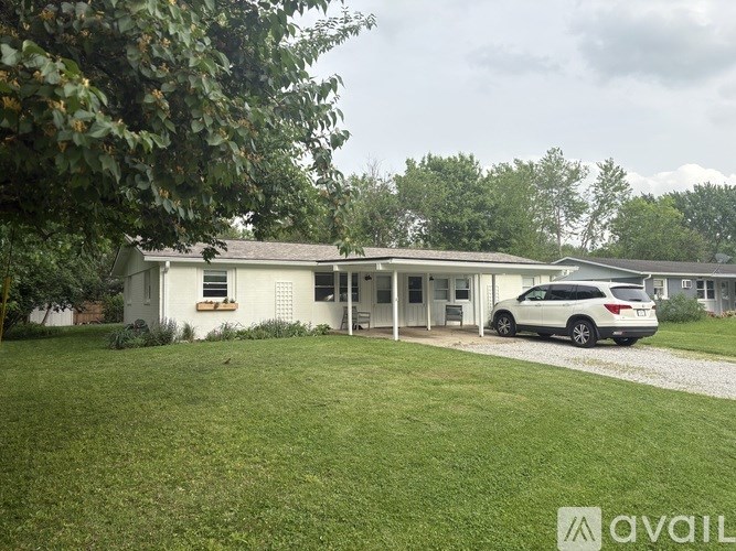 A house with a car parked in front of it.