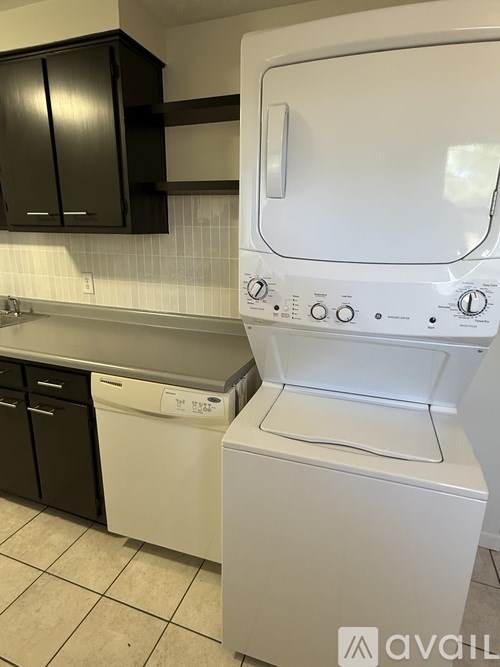 A white washing machine and dryer in a kitchen.