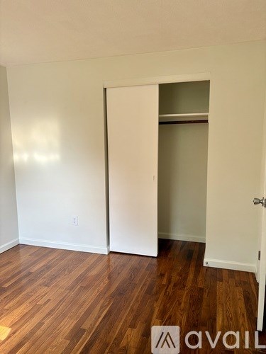 A room with a white door and a white wall.