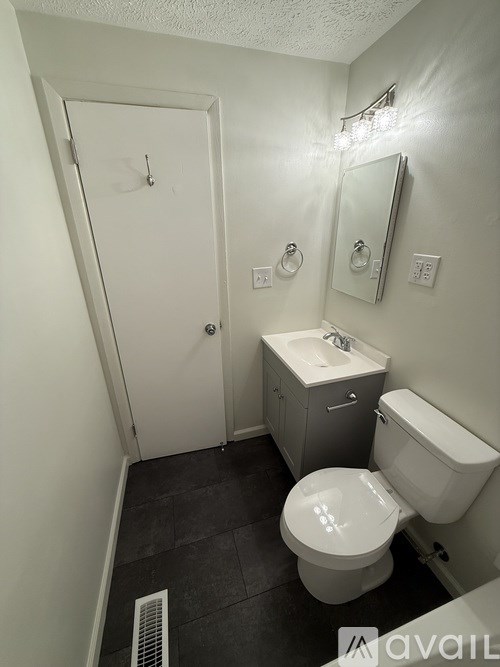 A white toilet sits next to a bathtub in a bathroom.