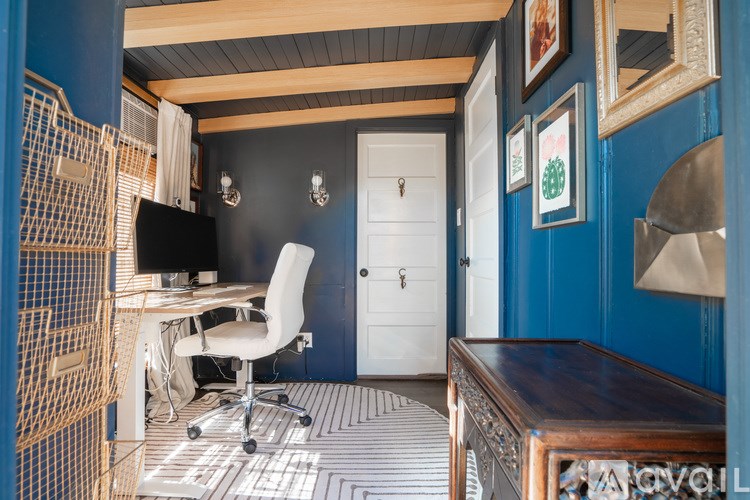 A room with a desk and a chair.