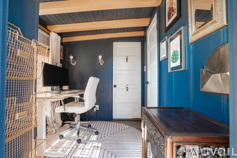 A room with a desk and a chair.