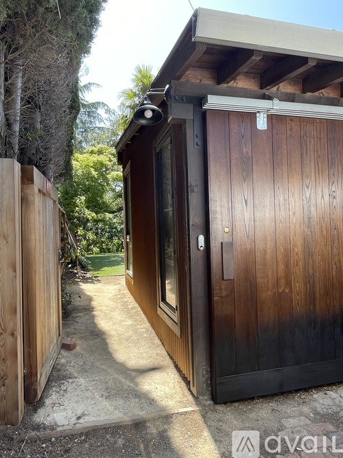 A wooden door with a black frame is closed.
