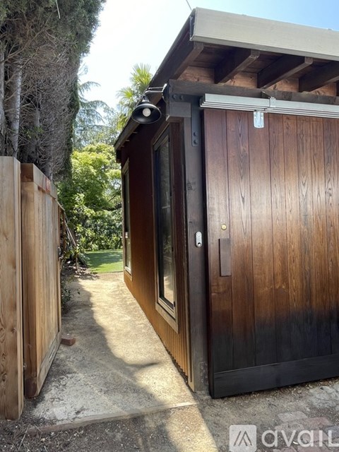 A wooden door with a black frame is closed.